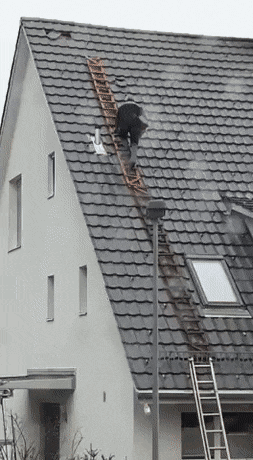 worker on unsafe ladder slides down roof in a near miss