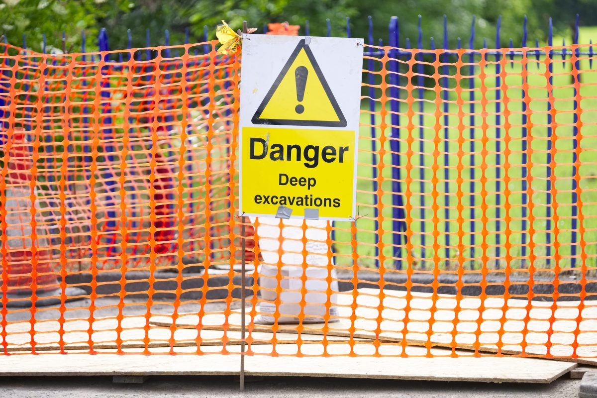 Danger Deep Excavation Sign And Orange Net Security