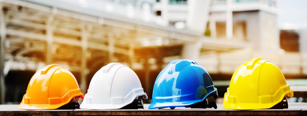 Head protection as hard hats, lined up in a row